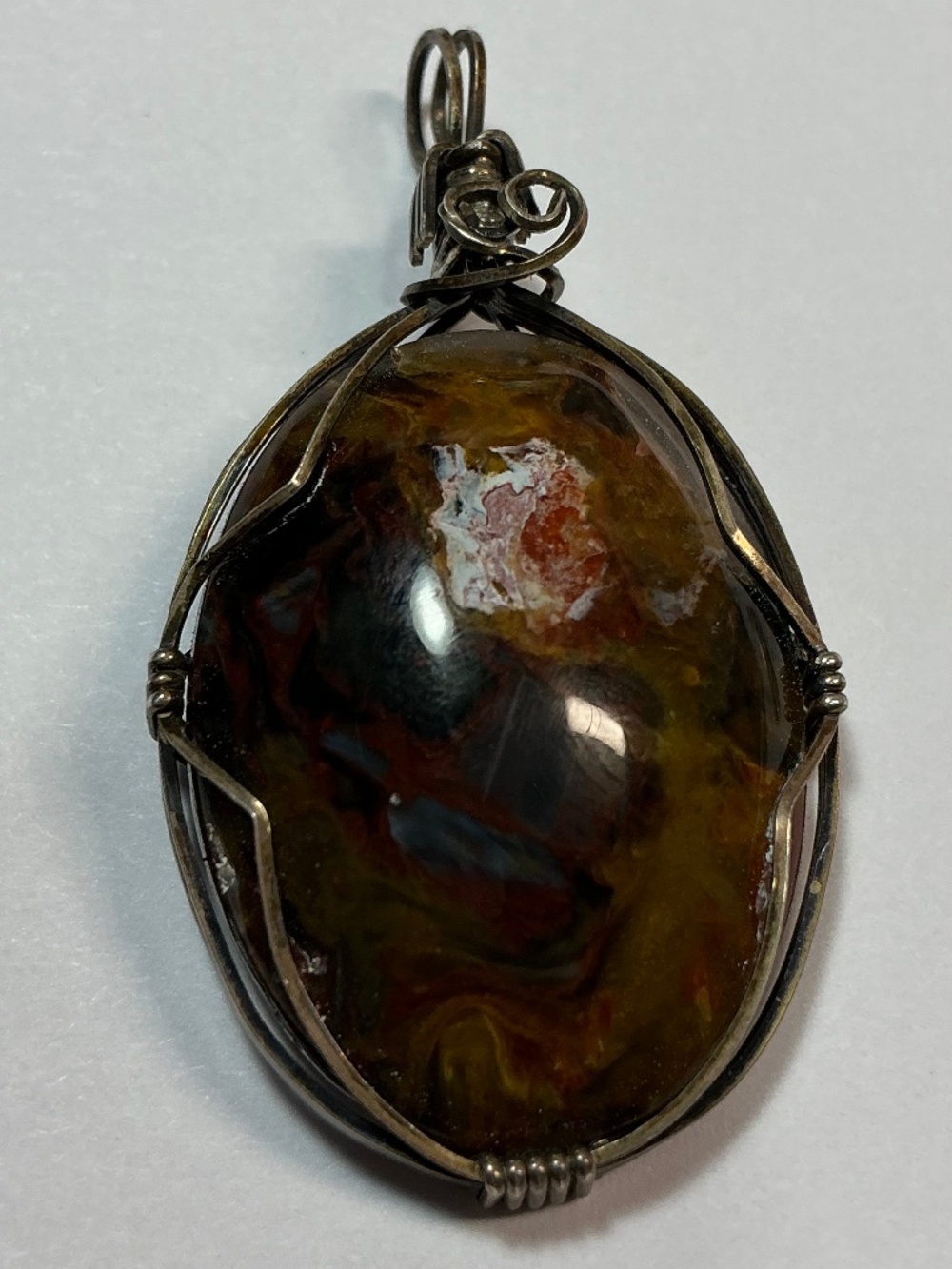 Sterling Silver Wire Wrapped Oval Shaped Pendant. 1.75 inches long